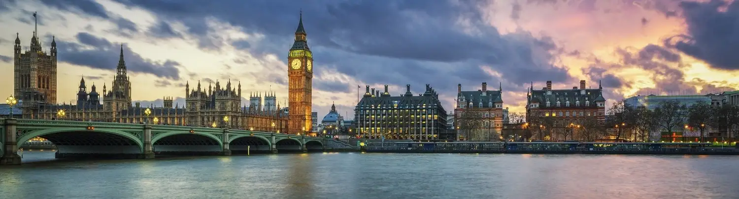 Students collaborating in a modern classroom with laptops
